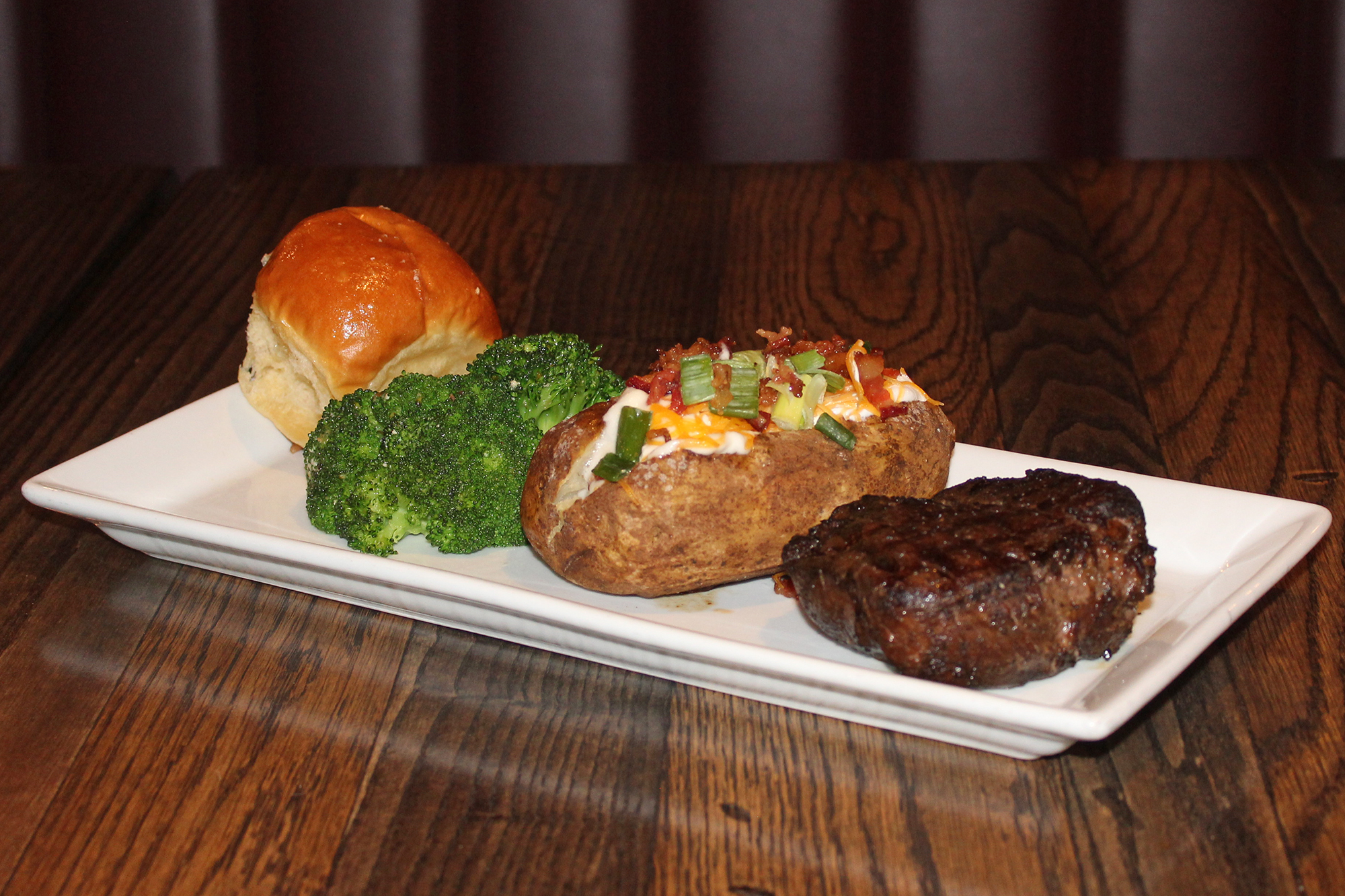Filet with baked potato, broccoli and roll